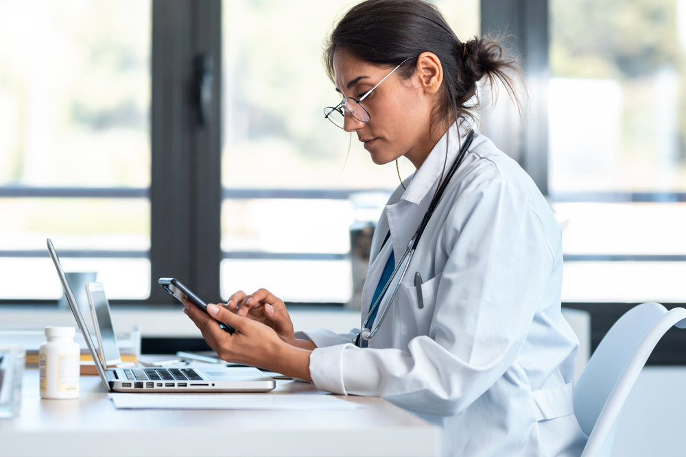Doctor Using Laptop and Tablet for Imaging Workflow