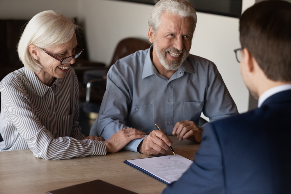 A couple reviewing paperwork with a doctor