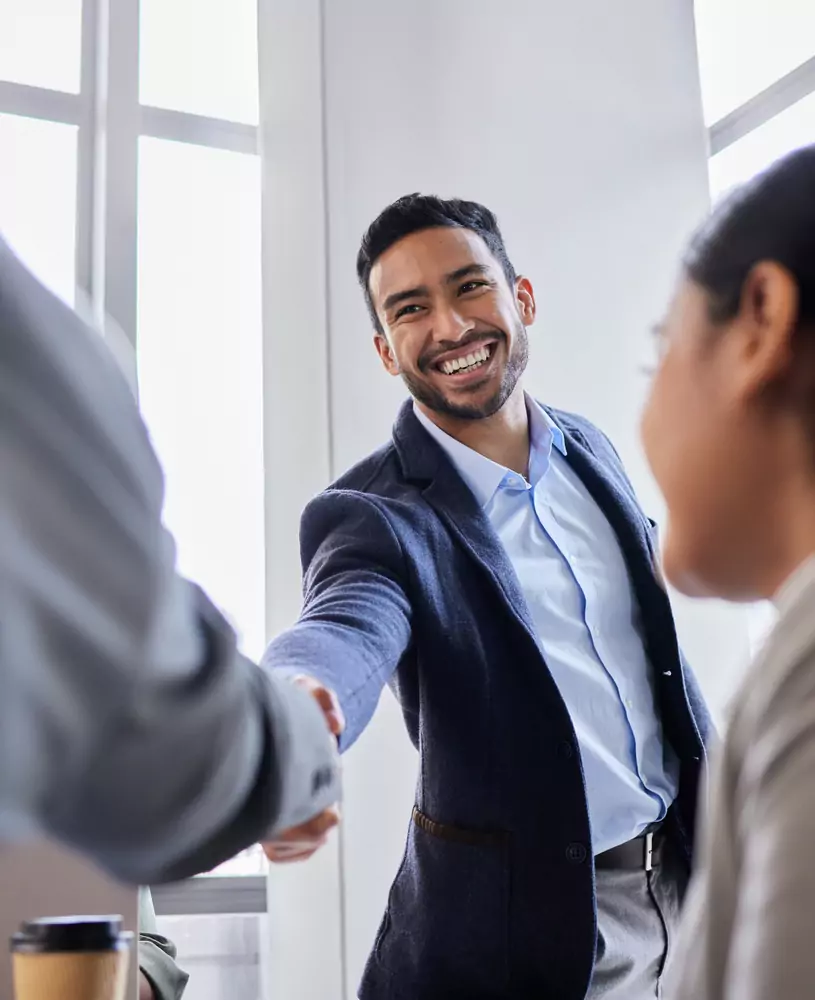 professional greeting a client with a smile, symbolizing ScImage’s customer-first philosophy.