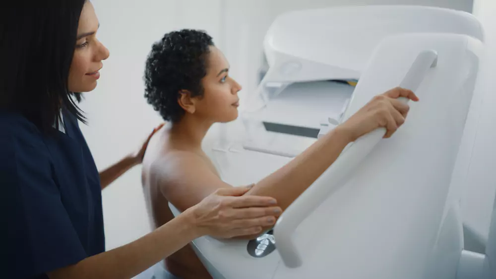 Woman undergoing a mammogram breast imaging exam