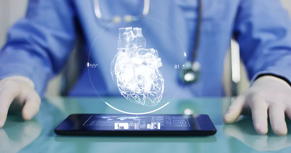A doctor using a tablet displaying a 3D digital heart image for medical imaging management