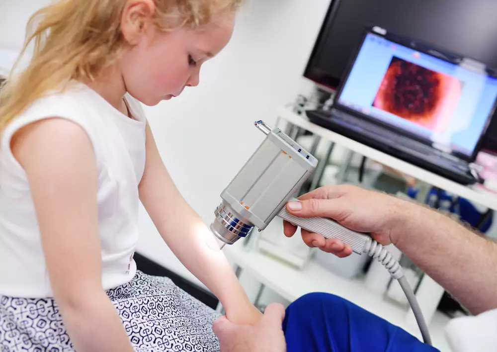 Physician capturing a clinical photograph of a child’s skin
