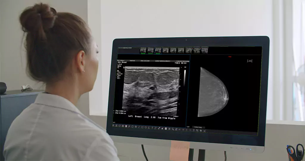 Doctor viewing breast ultrasound and mammogram images